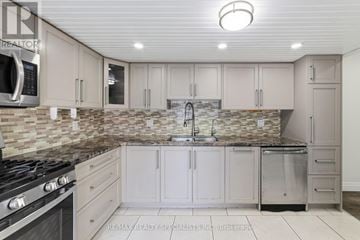 Hamilton (Huntington) apartment for rent - A kitchen with a stone backsplash and a stove top oven.