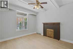 Hamilton apartment for rent - A room with a fireplace and a ceiling fan.