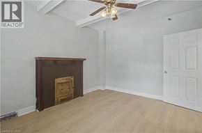 Hamilton apartment for rent - A room with a fireplace and a ceiling fan.