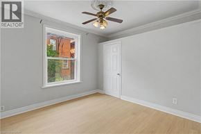 Hamilton apartment for rent - A room with a ceiling fan and a window showing a view of a building outside.