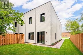 South Glengarry apartment for rent - A modern house with a white exterior and a wooden fence in front.