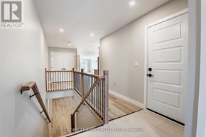 South Stormont townhouse for rent - A hallway with a staircase and a white door.