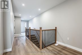 South Stormont townhouse for rent - A spacious room with a wooden railing and light colored walls.