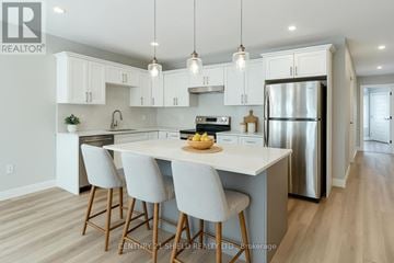 South Stormont townhouse for rent - A modern kitchen with white cabinets and a large island.