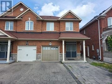 Milton (Be Beaty) apartment for rent - A large brick house with a garage and a driveway in front.