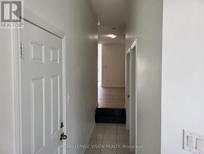 Milton (Be Beaty) apartment for rent - A hallway with a white door and a black mat on the floor.