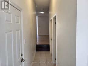 Milton (Be Beaty) apartment for rent - A hallway with a white door on the left and a black door on the right.