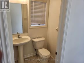 Milton (Be Beaty) apartment for rent - A white toilet sits next to a sink in a small bathroom.