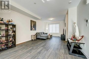 Hamilton (Vincent) townhouse for rent - A living room with a grey sofa and a wooden floor.