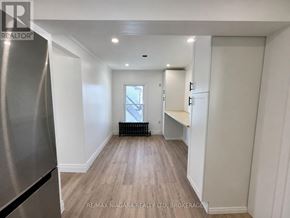 Welland (Lincoln/Crowland) apartment for rent - A spacious kitchen with a refrigerator on the left and a window in the middle of the room.