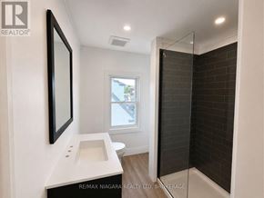 Welland (Lincoln/Crowland) apartment for rent - A bathroom with a white sink and a window.