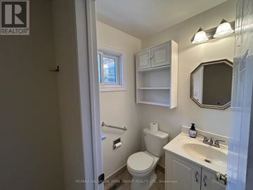 East Gwillimbury (Holland Landing) apartment for rent - A small bathroom with a toilet, sink, and medicine cabinet.