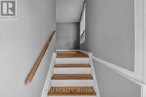 Ottawa apartment for rent - A staircase with wooden steps and a handrail.