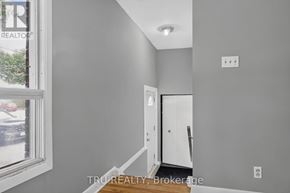 Ottawa apartment for rent - A room with a white door and a window showing a parking lot outside.