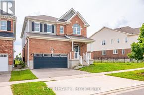 Cambridge apartment for rent - A house with a brick facade and a garage door is for sale.