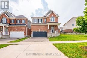 Cambridge apartment for rent - A large brick house with a white garage door is for sale.
