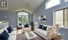 Niagara Falls (Oldfield) apartment for rent - A living room with white furniture and a large window.