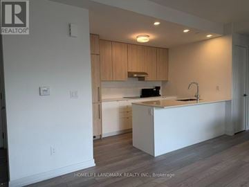 Richmond Hill townhouse for rent - A kitchen with white countertops and wooden cabinets.