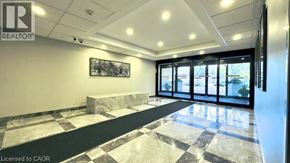 Hamilton condo for rent - A realtor office with a marble floor and a framed picture on the wall.