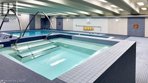 Hamilton condo for rent - A swimming pool in a well lit indoor swimming pool.