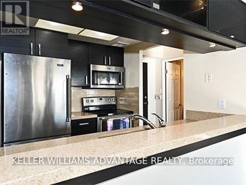 Toronto (Kennedy Park) condo for rent - A modern kitchen with a stainless steel refrigerator and a sink.