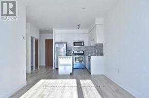 Toronto (Downsview-Roding-Cfb) condo for rent - A modern kitchen with white walls and a wooden floor.