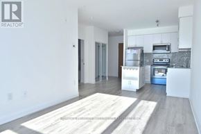 Toronto (Downsview-Roding-Cfb) condo for rent - A modern kitchen with white cabinets and a wooden floor.