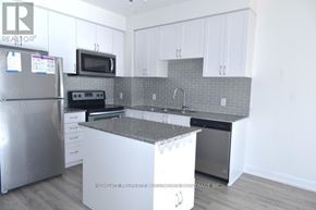 Toronto (Downsview-Roding-Cfb) condo for rent - A kitchen with a refrigerator, microwave, oven, and sink.