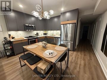 Ottawa fourplex for rent - A modern kitchen with a wooden table and chairs.