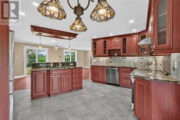 Alfred And Plantagenet apartment for rent - A kitchen with red cabinets and a large island.