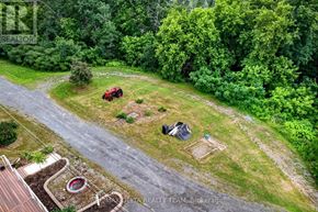 Alfred And Plantagenet apartment for rent - A red tractor is parked in a yard with a shed and a small garden.