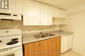 Richmond Hill (Harding) apartment for rent - A kitchen with a stove, sink and cabinets.