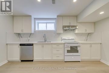 Mississauga (Lakeview) apartment for rent - A kitchen with white cabinets and appliances, including a dishwasher and oven.