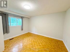 Mississauga (Lakeview) apartment for rent - A room with a wooden floor and a window with curtains.