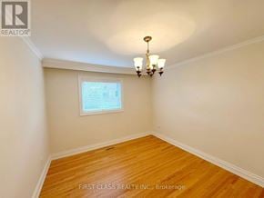 Mississauga (Lakeview) apartment for rent - A room with wooden floors and a chandelier.