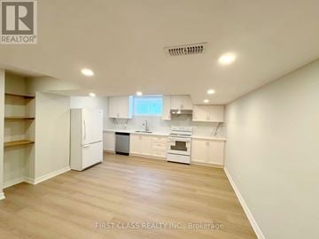 Mississauga (Lakeview) apartment for rent - A kitchen area with white appliances and wooden flooring.