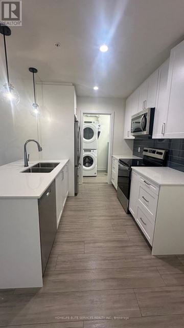 Clearview (Creemore) condo for rent - A modern kitchen with white cabinets and a wooden floor.