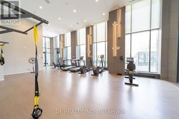 Toronto (Willowdale East) condo for rent - A gym with exercise equipment and a large window.