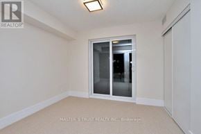 Toronto (Waterfront Communities) condo for rent - A room with a sliding glass door and a carpeted floor.
