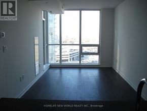 Toronto (Henry Farm) condo for rent - A room with a large window overlooking a parking lot.