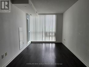 Toronto (Henry Farm) condo for rent - A room with a sliding glass door and wooden flooring.