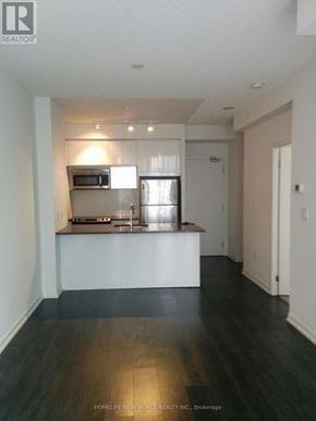 Toronto (Henry Farm) condo for rent - A kitchen with a refrigerator, microwave, and oven.