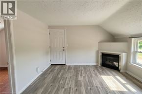 Brantford apartment for rent - A room with a fireplace and a door.