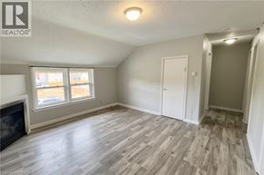 Brantford apartment for rent - A room with a fireplace and wood flooring.