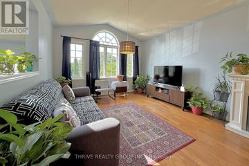 London South (South J) apartment for rent - A living room with a grey couch and a red rug.
