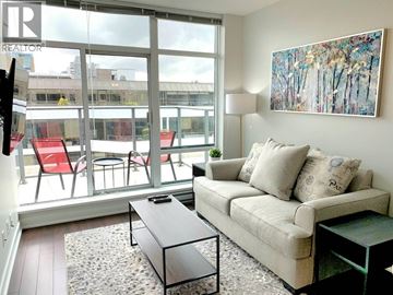 Vancouver apartment for rent - A living room with a couch, chairs, and a painting on the wall.
