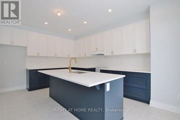 Ottawa apartment for rent - A kitchen with white cabinets and a white island.
