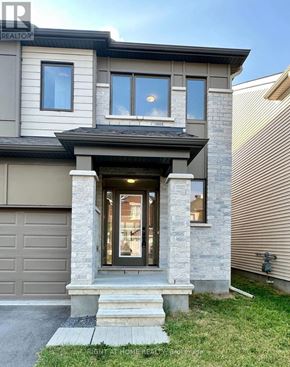 Ottawa apartment for rent - A modern house with a grey garage door and a stone pillar.