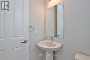 Ottawa apartment for rent - A bathroom with a sink, mirror and toilet.