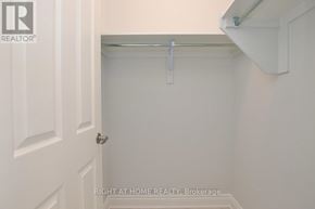 Ottawa apartment for rent - A white door with a handle and a brokerage sign on the wall.